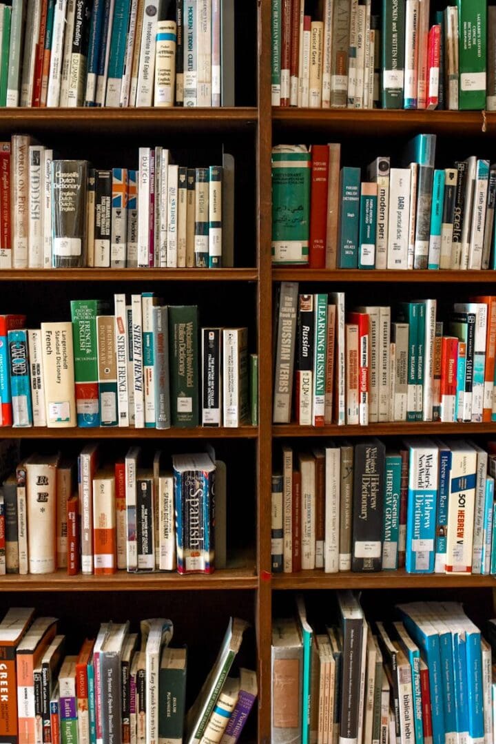 Vibrant library scene featuring wooden bookshelves filled with various books.
